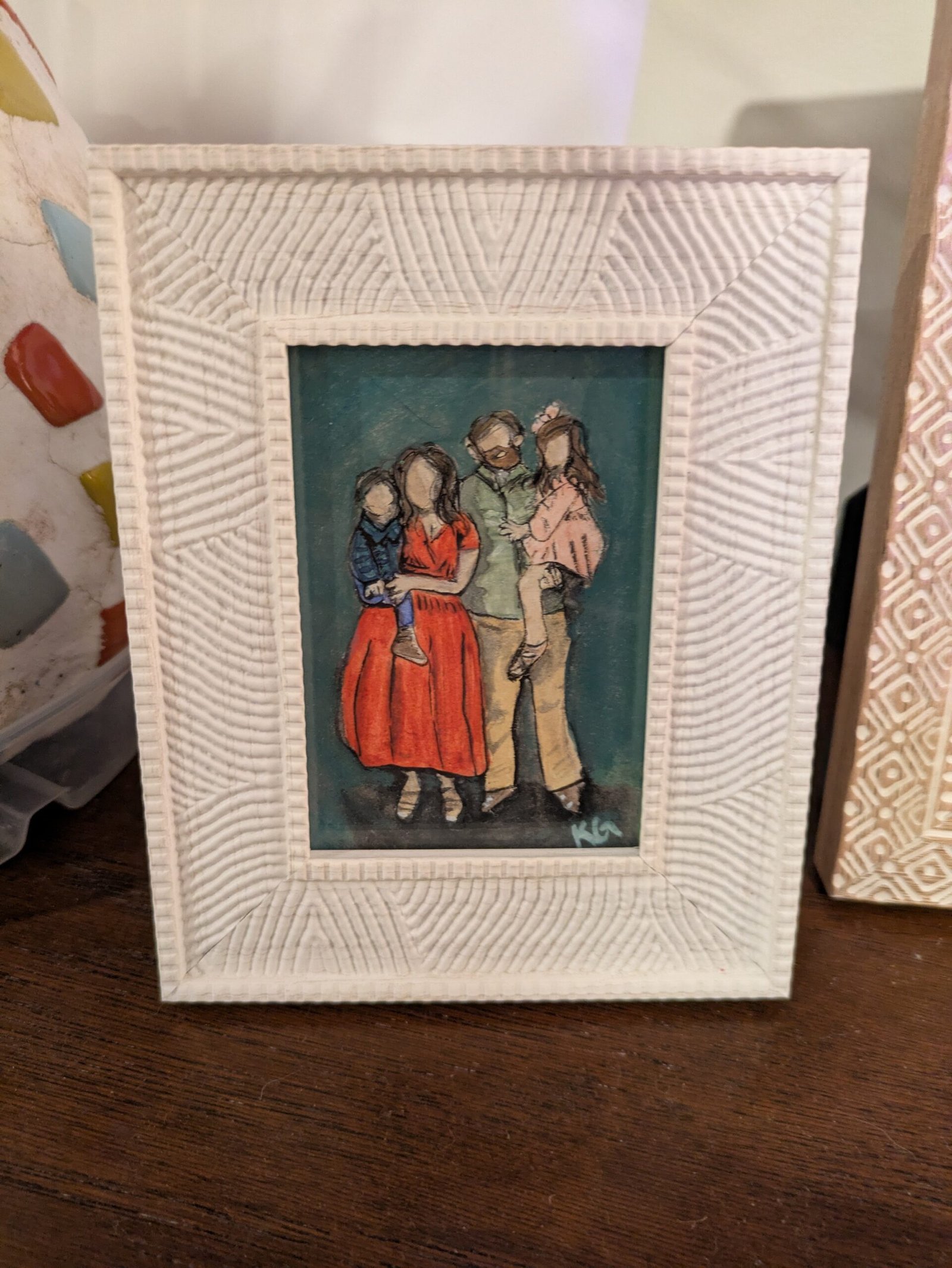 Framed watercolor portrait of a family of 4